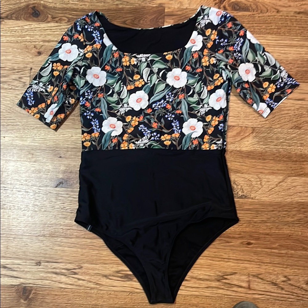 Bodyglove floral black short sleeve swimsuit.  Size large.  New with tags.